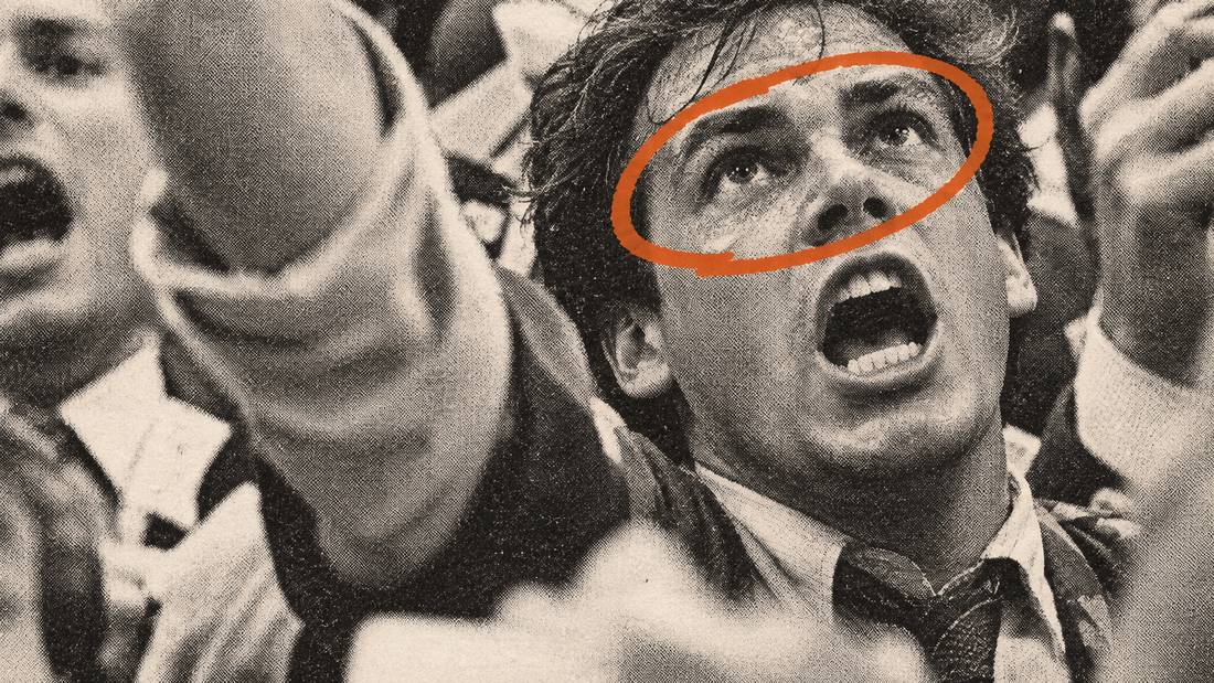 A trader's hand signalling a buy on the floor